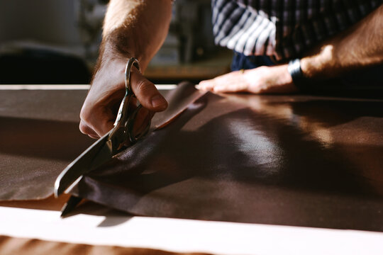 Clothier cutting fabric