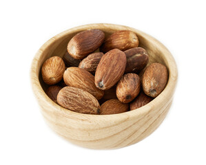 nutmeg whole muscat nut in wood bowl isolated on white background. nutmeg whole muscat nut isolated. pile of nutmeg whole muscat nut isolated                            