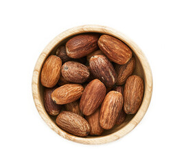 top view flat lay overhead nutmeg whole muscat nut in wood bowl isolated on white background. nutmeg whole muscat nut isolated. pile of nutmeg whole muscat nut isolated                            