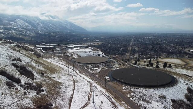 4K Drone footage filmed from above the road over the streets with cars and houses, snowy mountains in the distance, city streets, urban nature, Utah neighborhood, Utah state, SLC, Provo, Orem