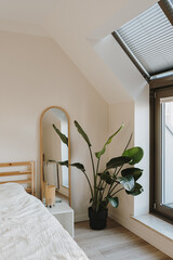 Modern home interior design concept. Tropical plant, window, mirror, bed with white linens. Minimal comfortable cozy living room © Floral Deco
