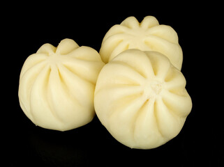 Group of steamed soft bao buns filled with hoisin sauce and duck meat