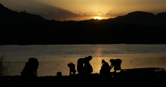 Borana people filling jerricans in a water reservoir Oromia Yabelo Ethiopia