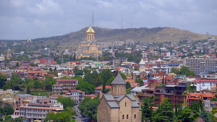 Fototapeta na wymiar landscape old Town and houses of Tbilisi , Georgia from Above Narikala fort: Holy Trinity Cathedral, Tranquil Lake Views, Peace Bridge Charm, Nmetekhi St. Virgin Church Heritage Zion Cathedral Majesty