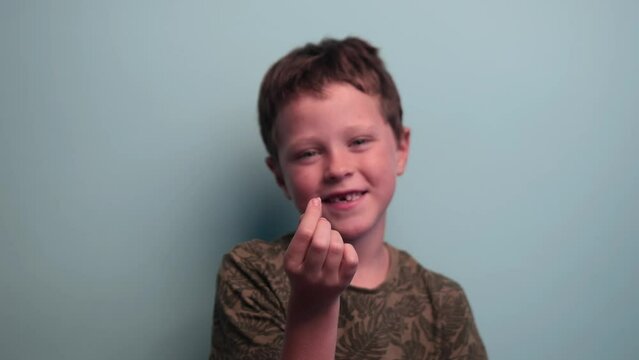 Schoolboy shows his baby tooth