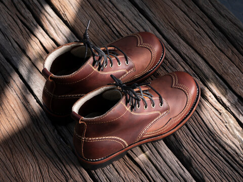 Man fashion brown boot leather on the floor.