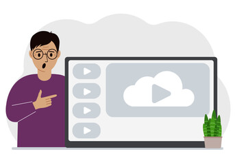 A man near a large screen TV, tablet or computer with a video play button. The concept of watching a video, channel or live broadcast.