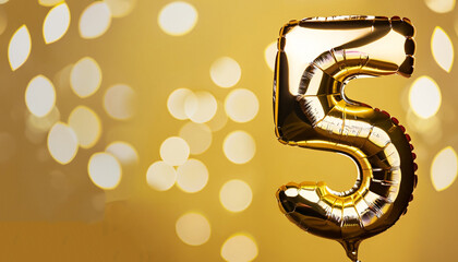 Banner with number 5 golden balloons with copy space. Five years anniversary celebration concept on...