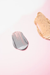 Smears of scrub for the skin on a pink background. Skin cleansing and exfoliation.