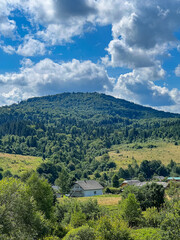 Fototapeta na wymiar Awesome Carpathian mountains landscape background with forest and clouds on the summer season 