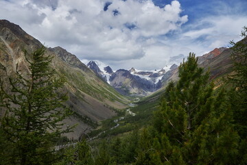 Beautiful landscape of mountain peaks, rivers and lakes. Wild nature of Altai Mountains. Clouds over mountain ranges. Russia, Altai Republic
