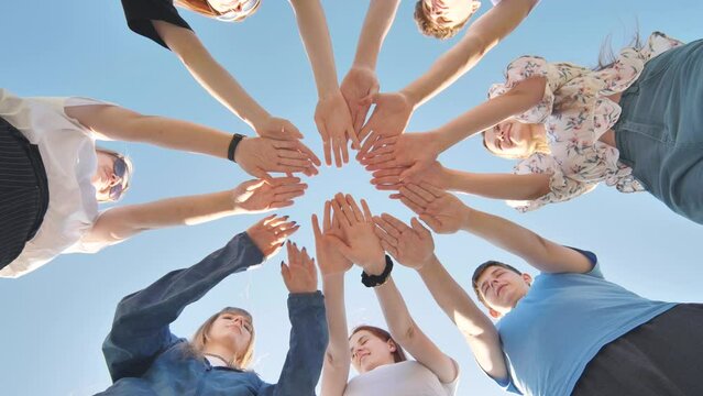 Seven boys and girls join hands as a sign of strong friendship.