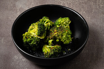 roasted broccoli in the dark bowl