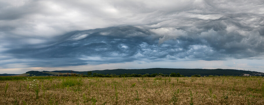 Panorama of a chaotic stormy sky over rural Transylvania in central Romania. Clouds are known in meteorology as Altocumulus asperitas and are often a harbinger of thunderstorms.