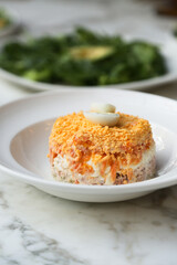 Traditional salmon salad with egg yolks