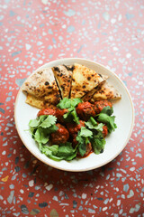 Meatballs with tomato sauce and flatbread