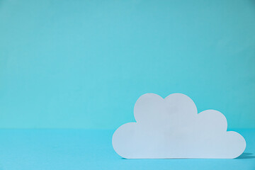 White paper cloud on a blue background, cloud computing concept, place for text