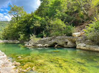Panoramic view of river Sentino with emerald water in the summer season, Marche region, Italy - 632503188