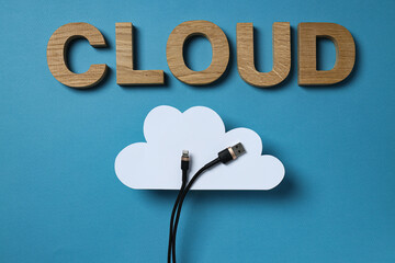 White paper cloud with a black USB cable and the word 