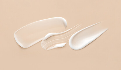 cosmetic smears of creamy texture on a beige background