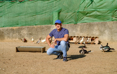 man on a small chicken and duck farm