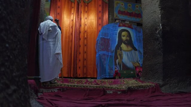 Pilgrim woman praying in a rock church Amhara Region Lalibela Ethiopia