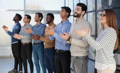 Fototapeta premium Close up side profile, different participants business people stand and express appreciation by clapping their hands