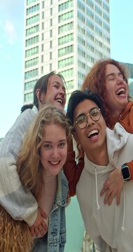 Vertical video. Selfie portrait of a group of young people having a good time.