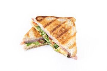 Panini sandwich with ham, cheese, tomato and arugula isolated on white background