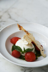Fresh burrata cheese with tomatoes and basil