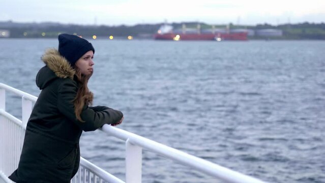 Young woman lost in thought on a ferry - slow motion clip 