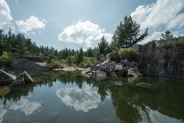 Reflections in the calm waters that fill an abandoned quarry