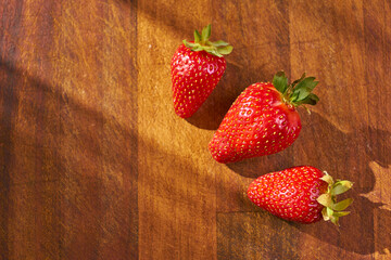 Fresh and juicy organic strawberries on chefs table.