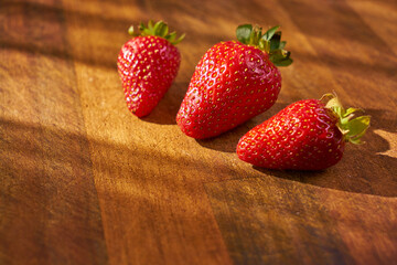Fresh and juicy organic strawberries on chefs table.