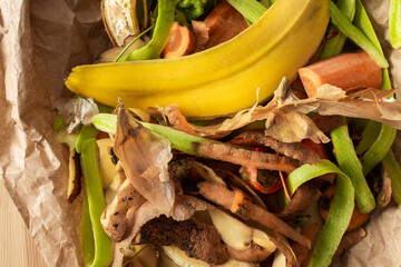 Food organic waste on eco friendly parchment paper, fruit and vegetable peel, garbage sorting and...