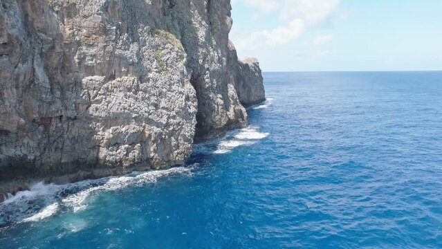 Flying close to cliffs rocky surface of Cabo Cabron national park In Samana, Dominican Republic. Aerial drone forward view