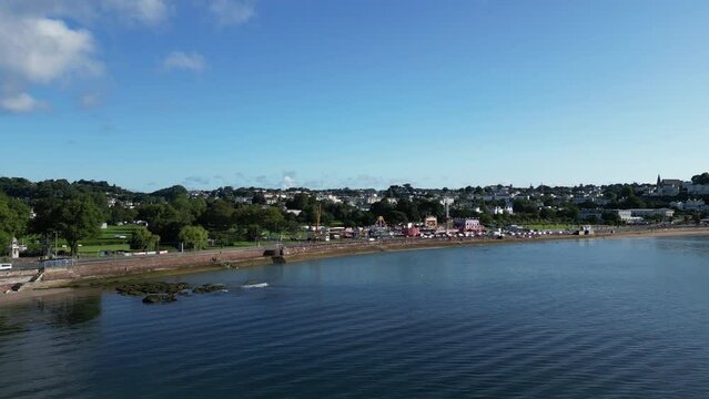 Torquay, Torbay, South Devon, England: DRONE VIEWS: The drone flies into the seashore at Torre Abbey Gardens for a view of the summer fairground / funfair. Torquay is a very popular UK holiday resort.
