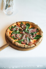 Pizza with prosciutto and basil