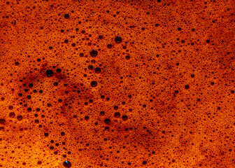 Bubbles and froth on the surface of a fresh brewed pot of pressed coffee