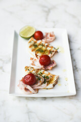 Grilled squid with tomatoes and lime