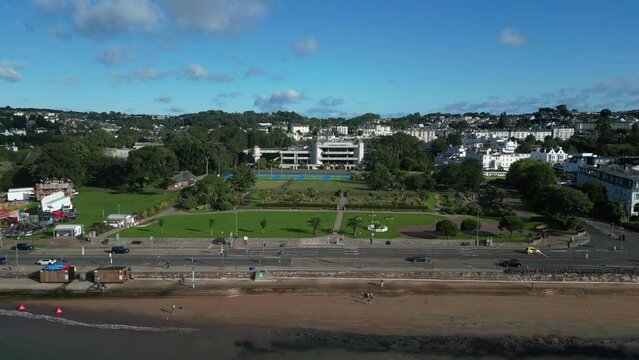 Torquay, Torbay, South Devon, England: DRONE VIEWS: The drone tracks r-to-l showing Torquay seafront, swimmers, joggers, Torre Abbey Gardens and traffic. Torquay is a popular UK holiday resort.