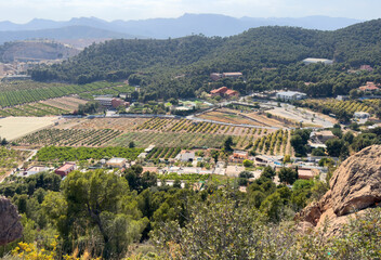 Obraz premium Villa in mountains. Rural landscape, aerial view. Farmhouse with garden field. Houses at mountain in countryside. House in farm field. Mountains landscape with farmland. Village Home in mountains.
