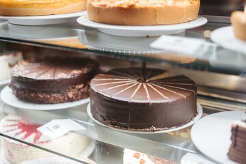 Delicious chocolate cake on display in a showcase at a restaurant