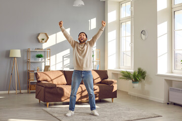 Free, happy, excited man having fun at home. Funny, joyful, crazy adult man having a day off,...