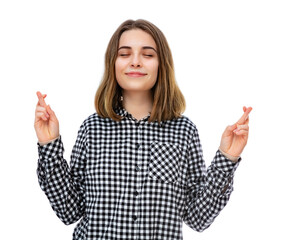 Portrait of beautiful young woman with fingers crossed, isolated on white background.  Pretty caucasian girl posing in studio. Concept of wishing for good luck or praying about something.