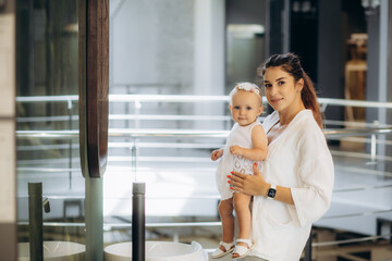 mother and daughter choose a bathtub in a sanitary ware store