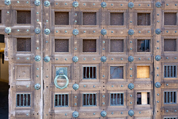 Liverpool Anglican Cathedral A close-up view to a part of old brown wooden door with metal rivets.