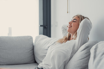 Young calm woman chilling relaxing leaning on comfortable sofa napping on couch in living room resting having healthy quiet nap, breathing fresh air, no stress free weekend at home, peace of mind. - Powered by Adobe