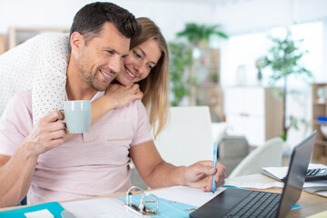 young couple managing finances at home