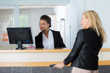 receptionist helping a hotel guest check in